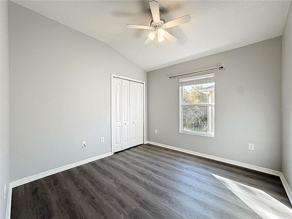 1500 Broken Oak Drive, Unit 25B Winter Garden, FL 34787 - Photo 45 of 62 an empty room with wooden floor chandelier fan and windows