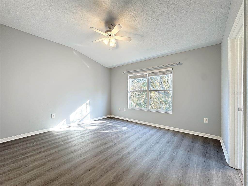 1500 Broken Oak Drive, Unit 25B Winter Garden, FL 34787 - Photo 48 of 62 a view of an empty room with wooden floor and a window