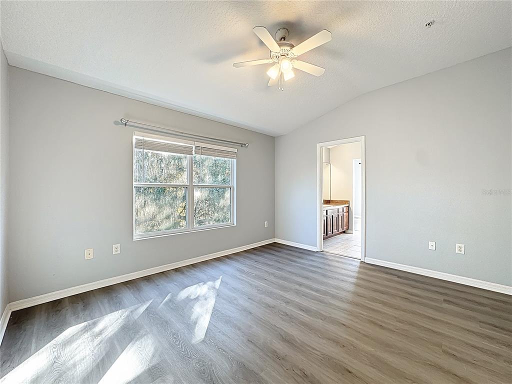 1500 Broken Oak Drive, Unit 25B Winter Garden, FL 34787 - Photo 49 of 62 a view of an empty room with wooden floor and a window