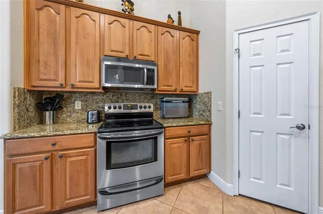 a kitchen with granite countertop a sink and cabinets