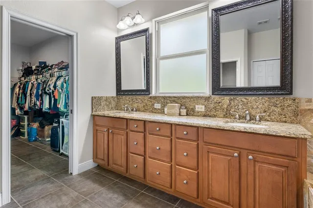 a bathroom with a sink vanity and mirror