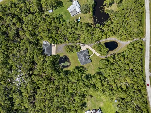 a front view of a house with a garden and yard
