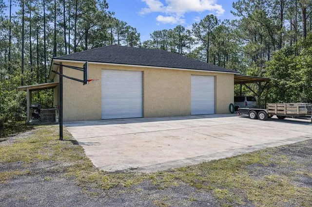 a house with lots of trees in the background