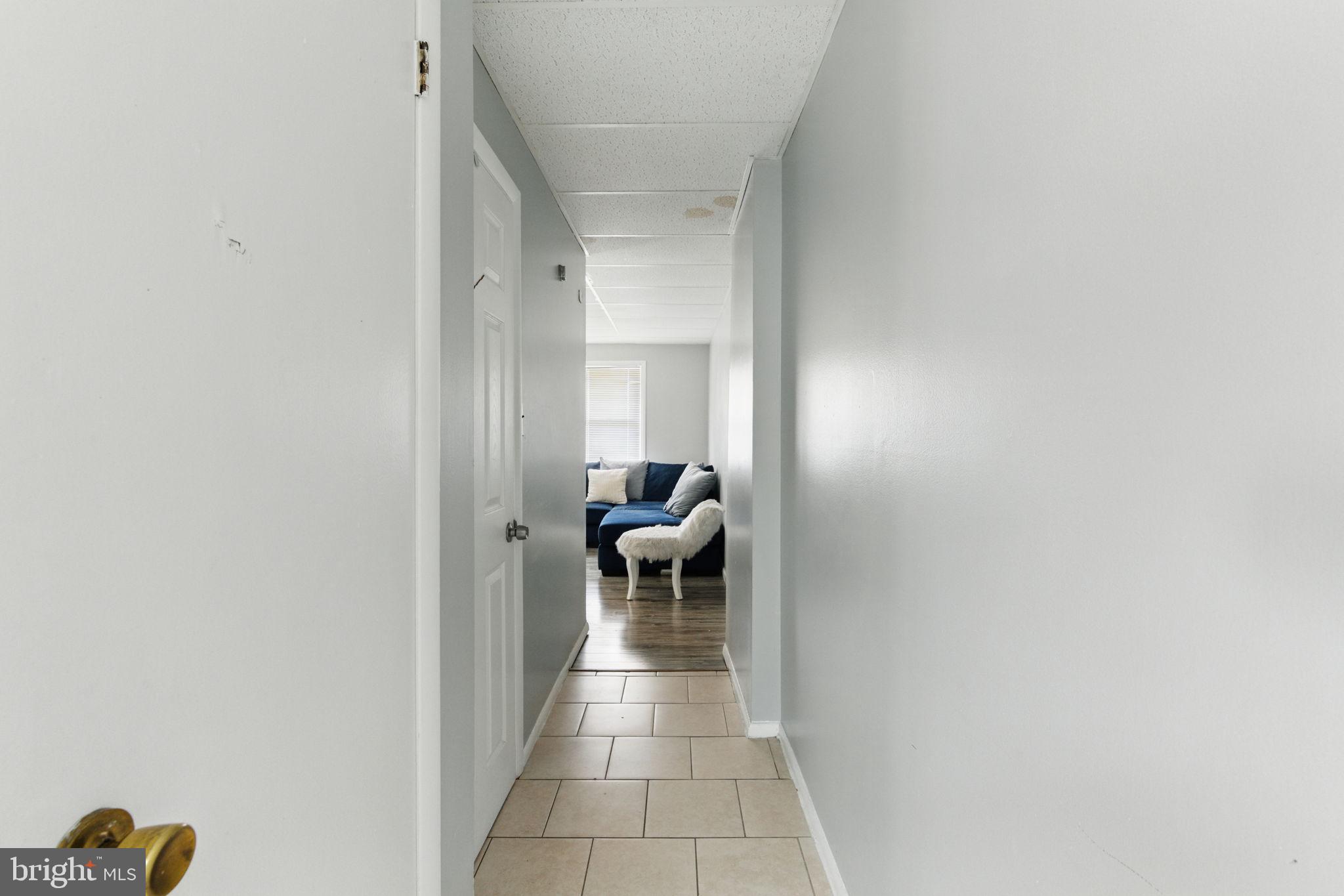 4508 Post Road Marcus Hook, PA 19061 - Photo 16 of 38 a hallway with a couch and a dining table