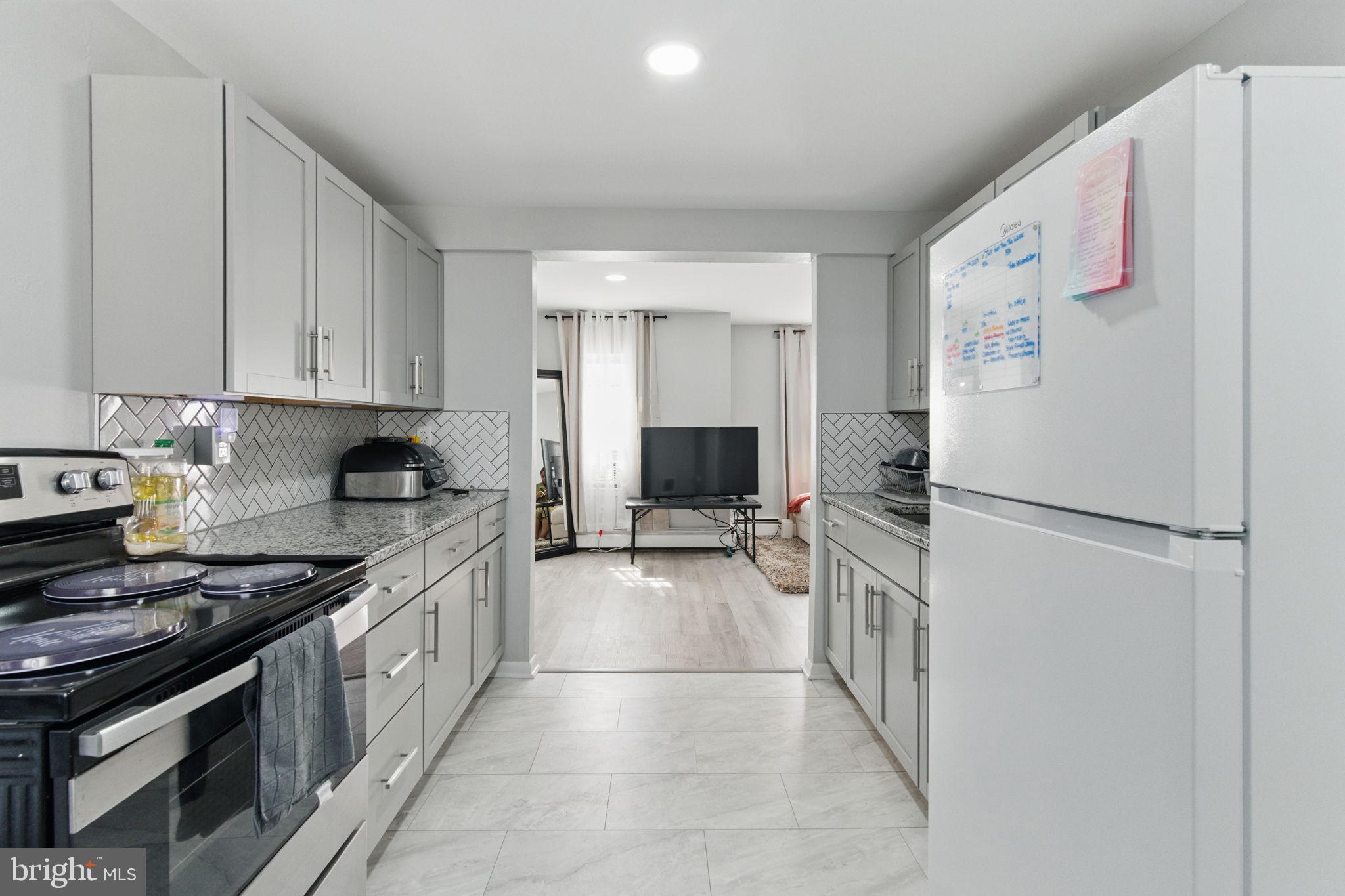 4508 Post Road Marcus Hook, PA 19061 - Photo 27 of 38 a kitchen with a refrigerator and a stove top oven