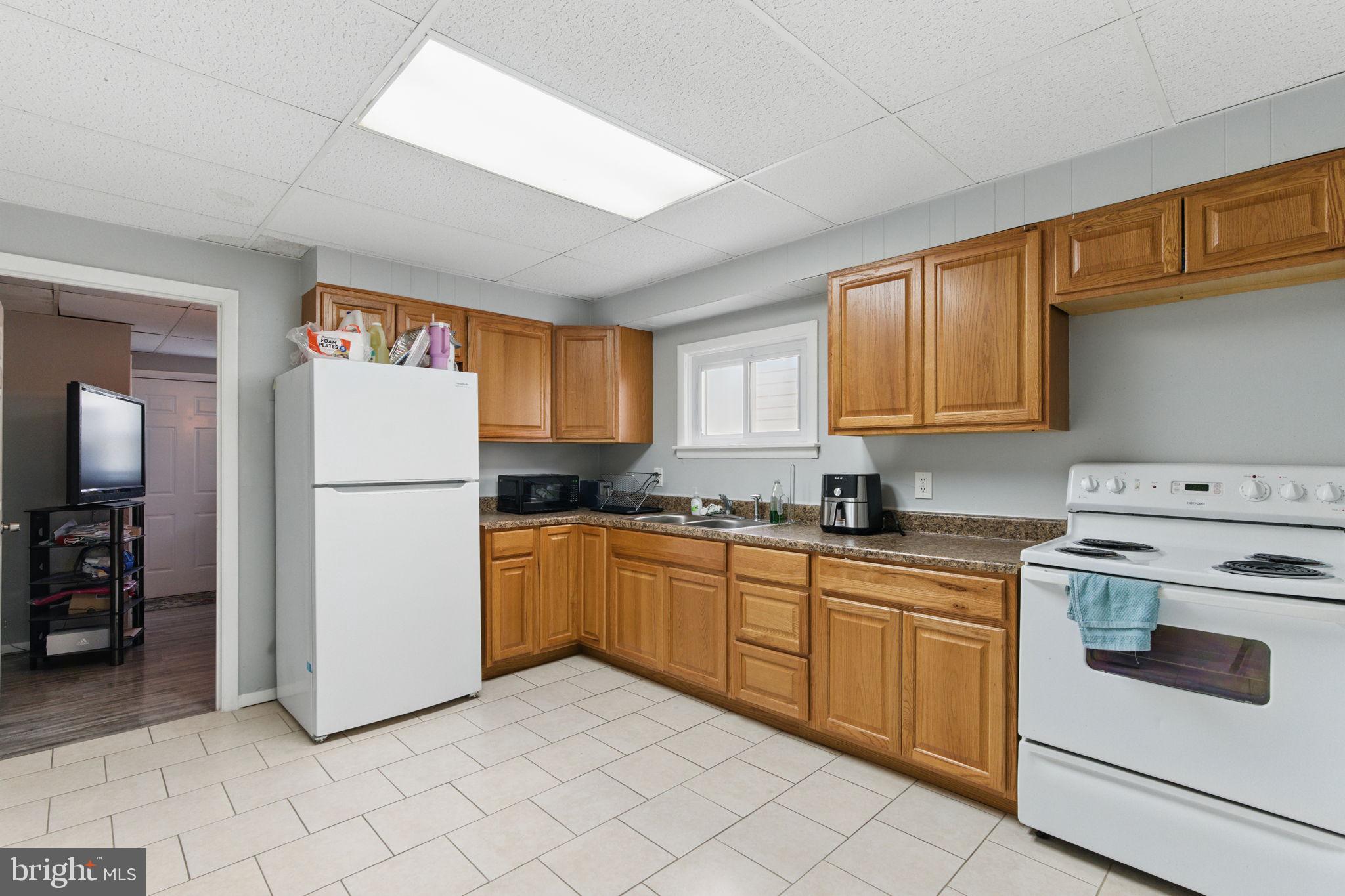 4508 Post Road Marcus Hook, PA 19061 - Photo 9 of 38 a kitchen with a refrigerator sink stove and cabinets