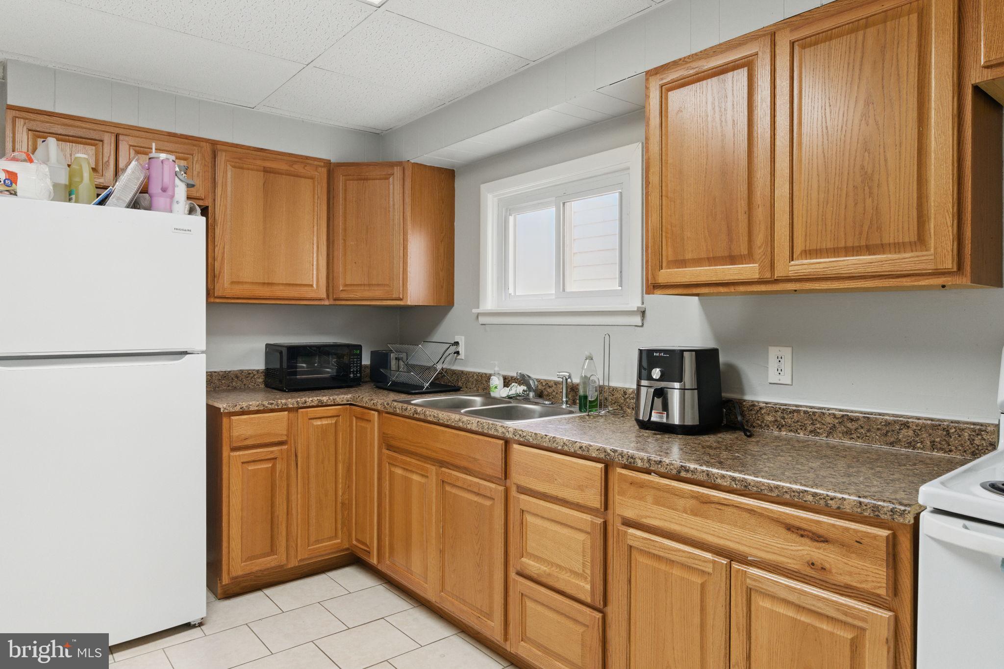 4508 Post Road Marcus Hook, PA 19061 - Photo 10 of 38 a kitchen with stainless steel appliances granite countertop a sink a refrigerator and cabinets
