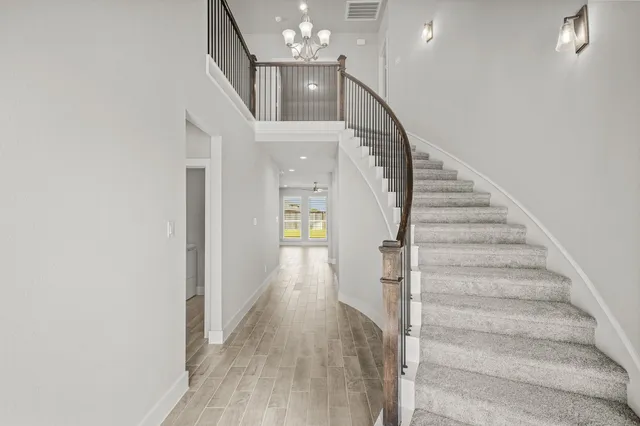 a view of entryway and hall with wooden floor