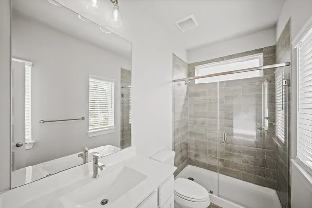 a bathroom with a sink toilet and shower