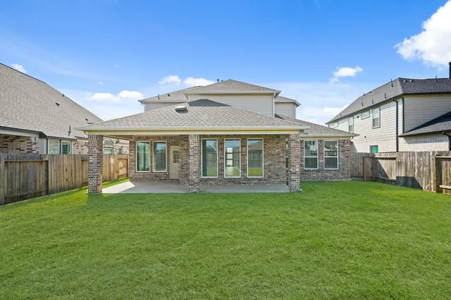 a view of a house with a yard and sitting area
