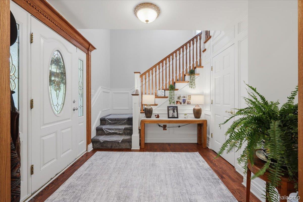 5685 Crescent Road Waterford, MI 48327 - Photo 6 of 47 Entryway featuring wood-finish flooring and a white paneled front door with decorative glass inserts