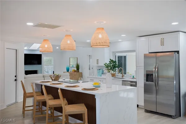 a kitchen with stainless steel appliances a dining table and chairs