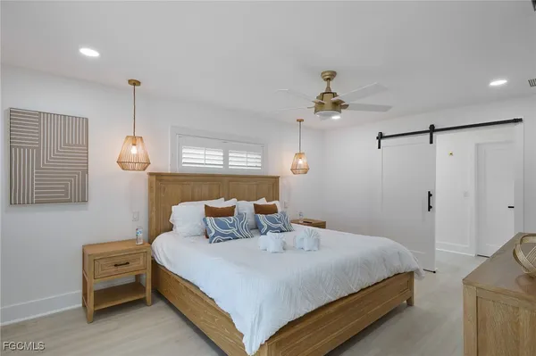 a bedroom with a bed and a chandelier