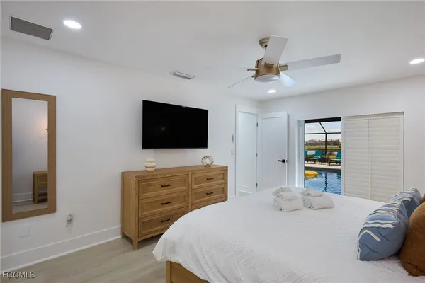 a bedroom with a bed and a flat screen tv