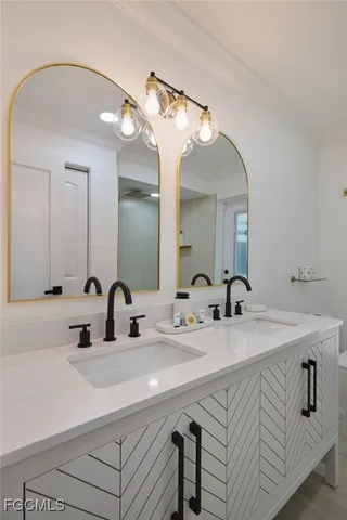 a bathroom with a double vanity sink and a mirror
