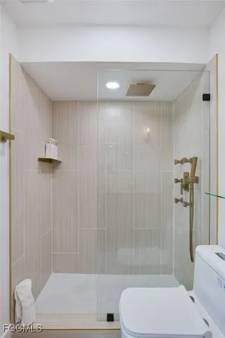 a bathroom with a toilet and a shower