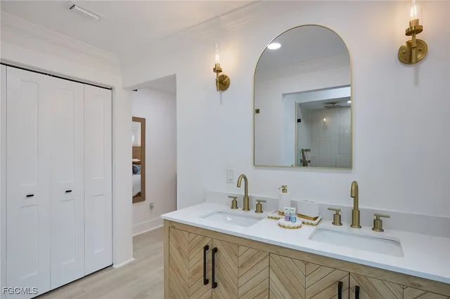 a en suite bathroom with a granite countertop sink and a mirror