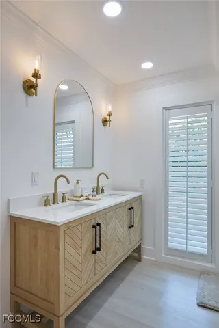 a bathroom with a granite countertop sink a large mirror and a window