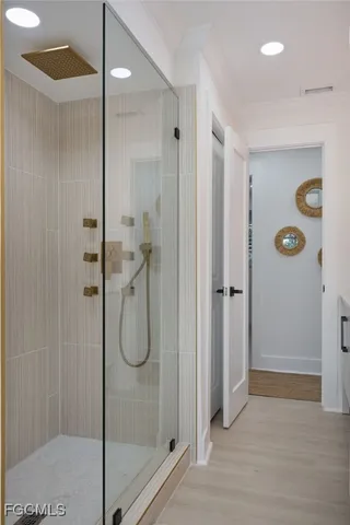 a bathroom with a glass shower door