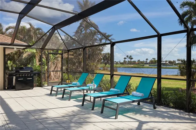 a view of a patio with a table chairs and a backyard