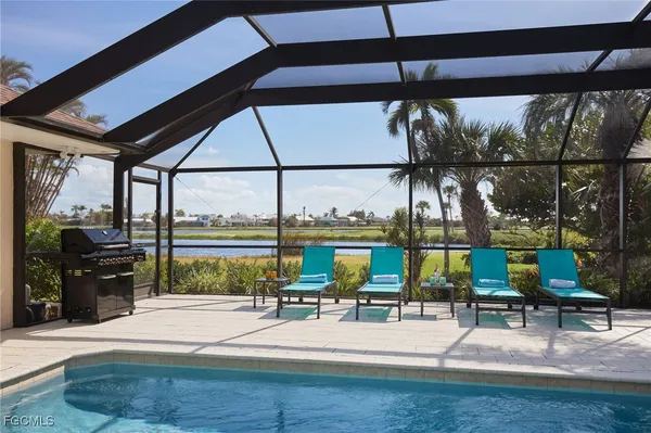 a view of swimming pool with sitting area
