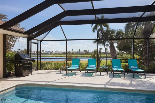 a view of swimming pool with sitting area