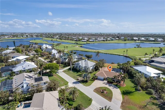 an aerial view of a house with a lake view