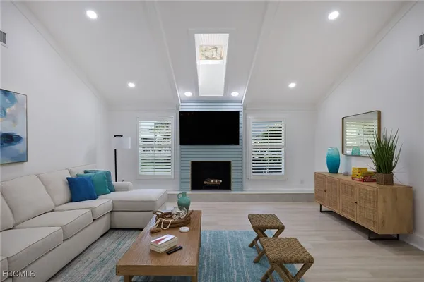a living room with furniture flat screen tv and a fireplace