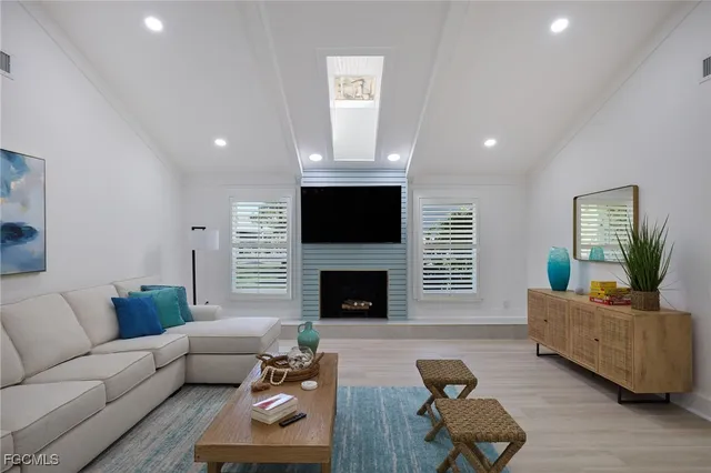a living room with furniture flat screen tv and a fireplace