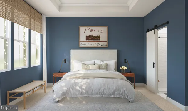 a bedroom with a bed and a large window