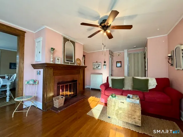 a kitchen with a refrigerator wooden floor and cabinets
