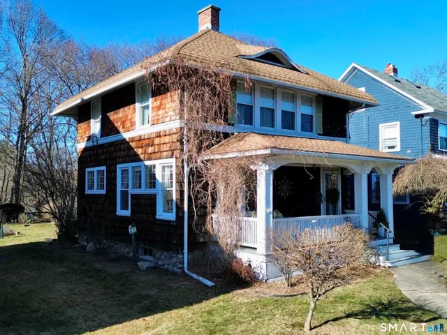 an aerial view of a house with garden space and street view