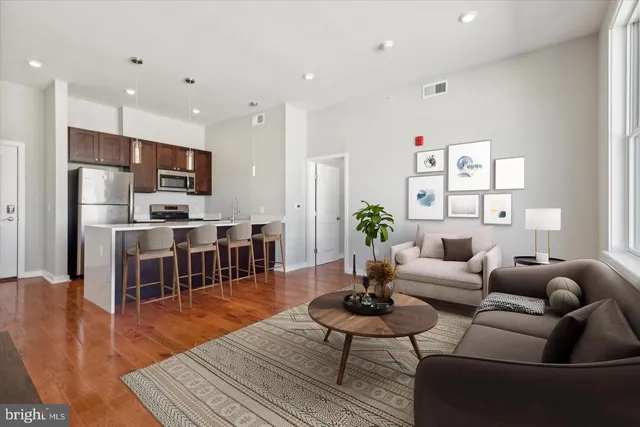 a living room with furniture kitchen view and a dining table