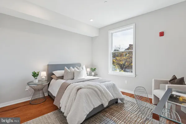 a bedroom with bed and a window