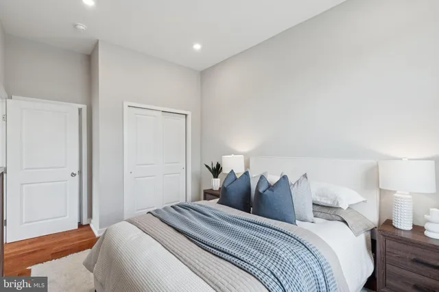 a bed room with a bed and a night stand