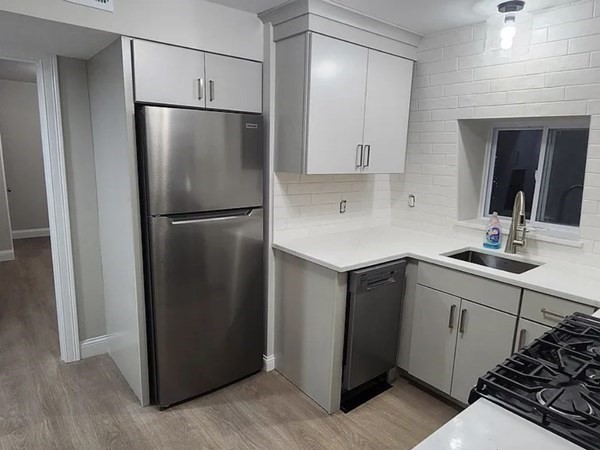 322 Brownell Street, Unit 3W Fall River, MA 02720 - Photo 2 of 10 a kitchen with a sink and a refrigerator