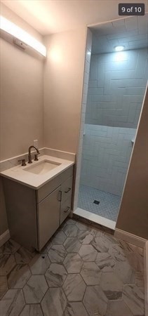 322 Brownell Street, Unit 3W Fall River, MA 02720 - Photo 4 of 10 a bathroom with a sink shower and a mirror