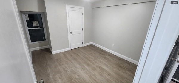322 Brownell Street, Unit 3W Fall River, MA 02720 - Photo 8 of 10 an empty room with wooden floor