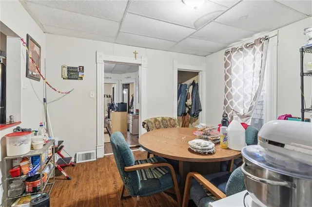 a view of a dining room with furniture and a chandelier