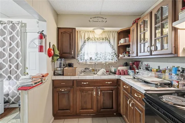 a kitchen with a refrigerator and a stove top oven