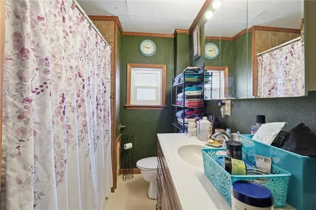 a bathroom with a toilet sink and mirror