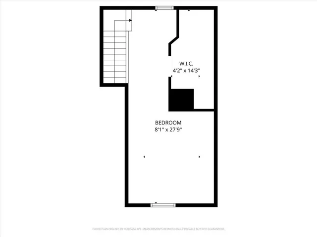 a bedroom with a bed next to a window