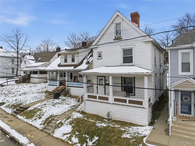 an aerial view of residential houses with city view