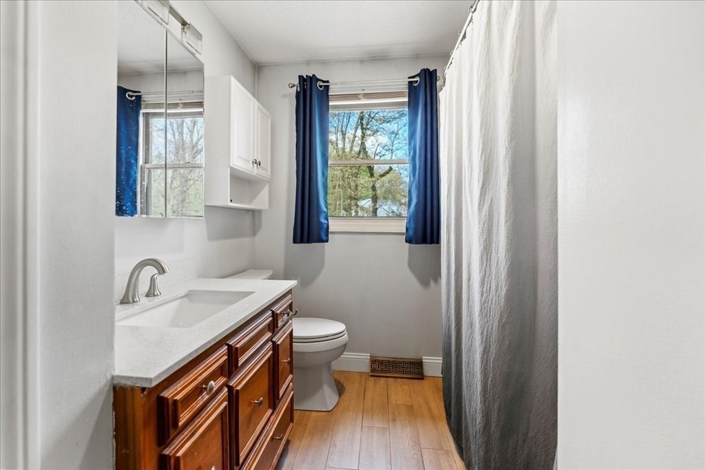 160 University Street Springfield, MA 01104 - Photo 15 of 30 a bathroom with a sink a toilet and a mirror