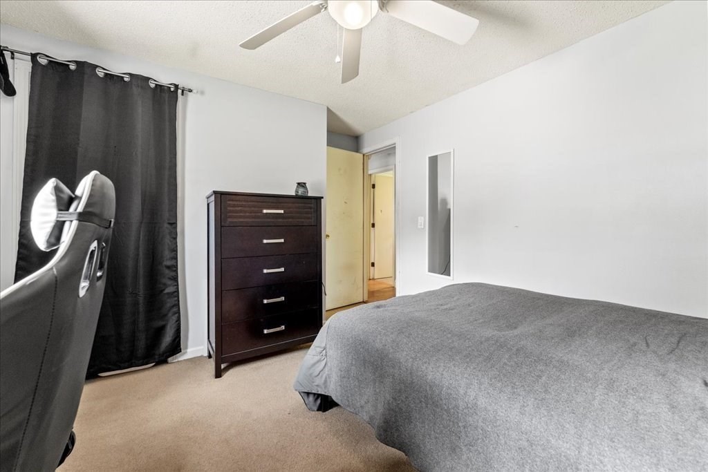 160 University Street Springfield, MA 01104 - Photo 18 of 30 a bedroom with a bed dresser and a chandelier