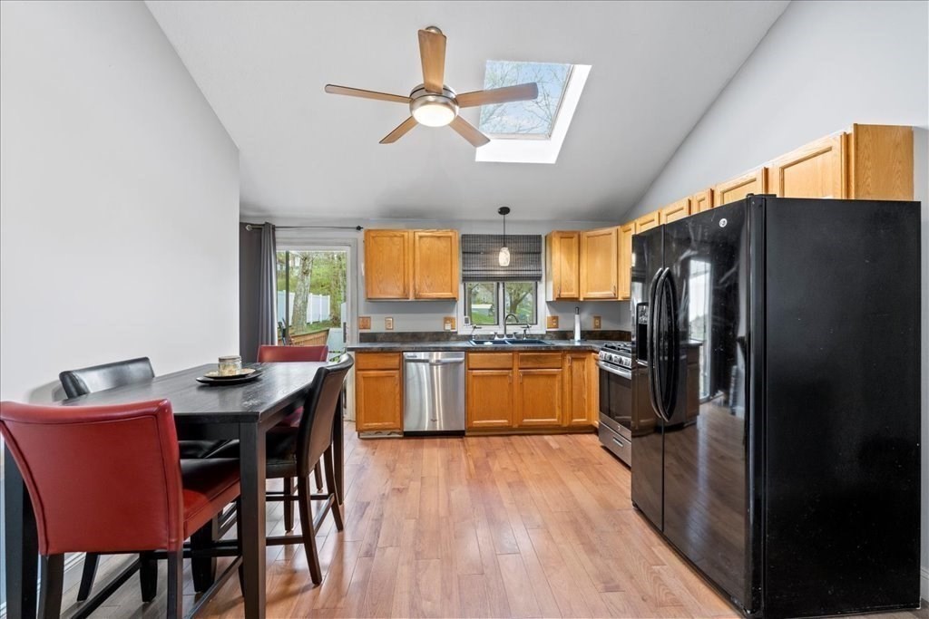 160 University Street Springfield, MA 01104 - Photo 4 of 30 a kitchen with stainless steel appliances granite countertop a refrigerator a sink dishwasher a dining table and chairs with wooden floor