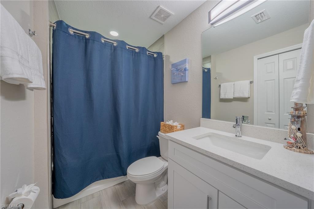 8152 Pelican Road Fort Myers, FL 33967 - Photo 22 of 24 Bathroom featuring a white vanity with integrated sink, a light-colored countertop, and a shower with a privacy curtain