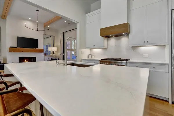 a kitchen with a table and a stove top oven