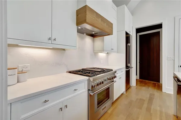 a kitchen with stainless steel appliances a stove and a refrigerator