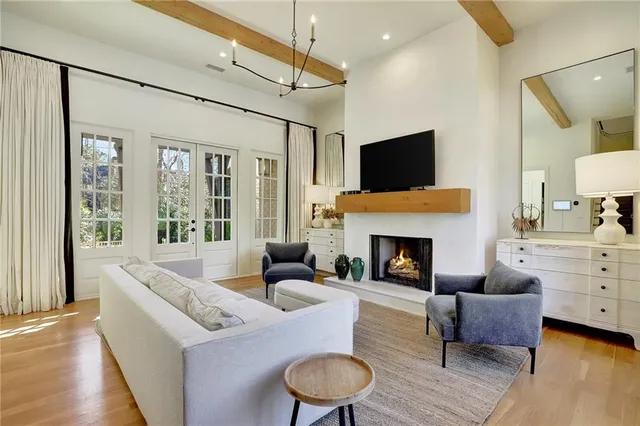 a living room with furniture fireplace and window